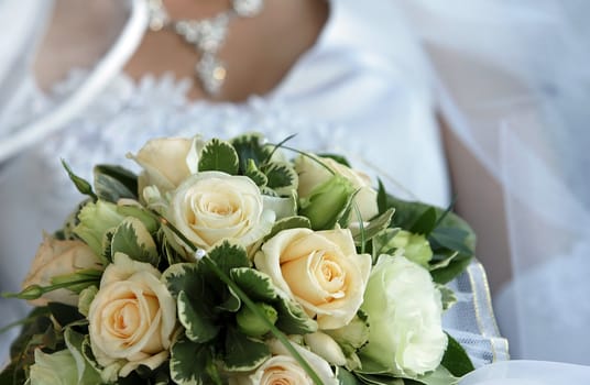 The bride holds a wedding bouquet