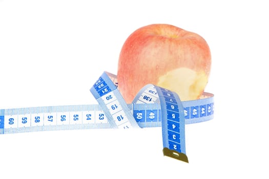 closeup of an apple with a  centimeter on white background