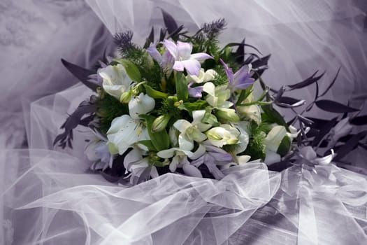 Wedding bouquet on a background of a veil