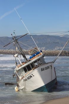 VENTURA, CA, USA - January 8, 2010 - The fishing boat SAI GON I ran aground after 4 people were rescued early morning. The rescue team tried to free the boat throughout the day January 8, 2010 in Ventura, CA