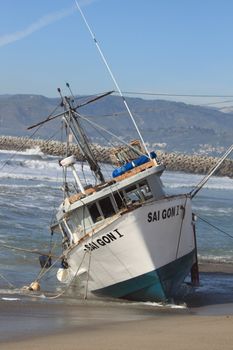 VENTURA, CA, USA - January 8, 2010 - The fishing boat SAI GON I ran aground after 4 people were rescued early morning. The rescue team tried to free the boat throughout the day January 8, 2010 in Ventura, CA