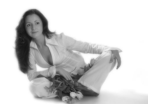 Portrait of a beautiful brunette with tulips. b/w