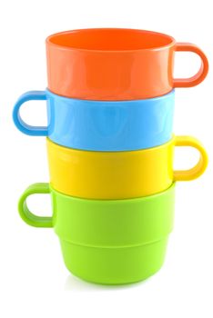 Four piled up plastic cups in different colors, isolated on white.
