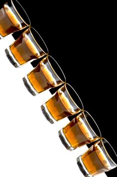 Glass of whisky isolated over white and black background