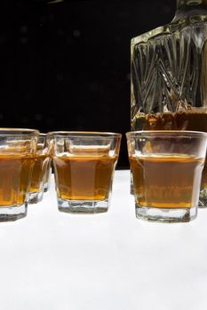 Glass of whisky isolated over white and black background