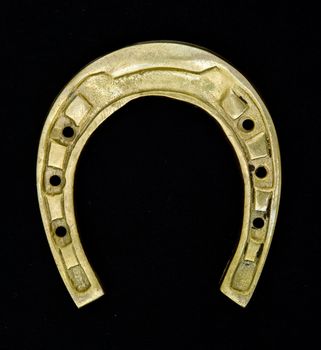 Amulet. Horseshoe on a black background