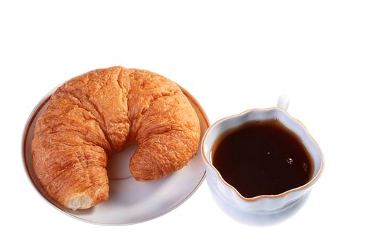 Cornetto on a saucer with a cup of black tea.