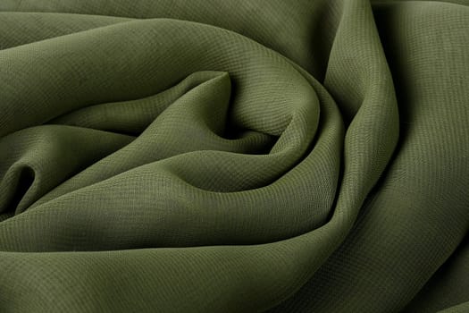 Darkly green fabric as a background for design works.