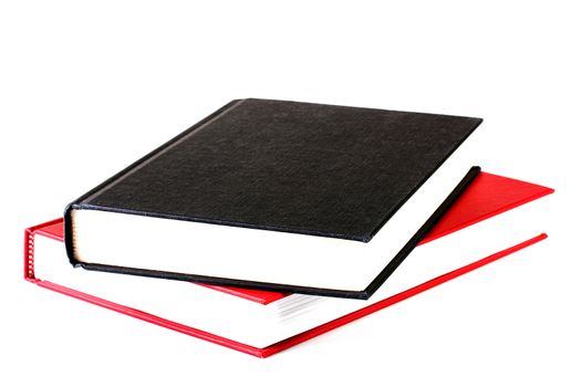 The black closed book lies on red both books on a white background.