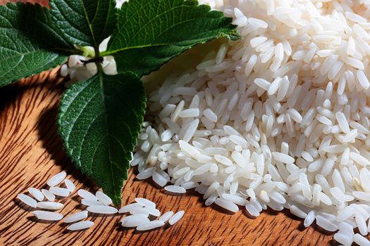 Rice in a wooden plate with mint leaves.