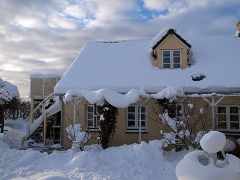 Beautiful traditional country house home in winter covered with snow