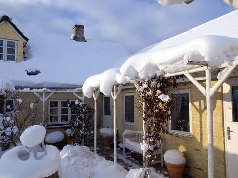 Beautiful traditional country house home in winter covered with snow