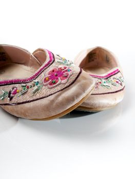 A set of woman / girl slippers, with some bead-work and stitching, isolated on white.