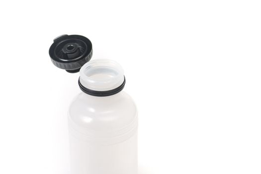 An plastic water bottle, with an open top, isolated on white.