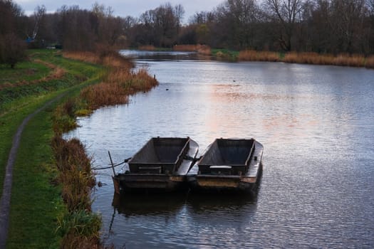 Iron boats are used for cutting the reed at the waterside - horizontal image