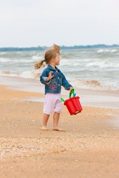 people series: little girl on the beach play with toy
