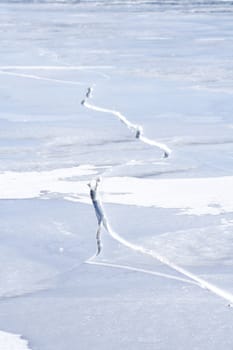 Large crack on ice on a frozen lake