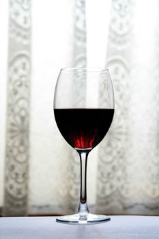 glass of wine over white and gry background
