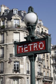 Metro Sign And Street Lamp In Paris, Typical Parisienne Building Facade