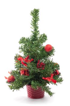 A small decorated Christmas tree on white background