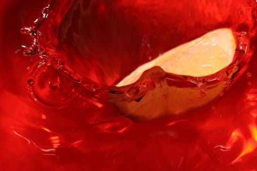 Lemon drop in red liquid