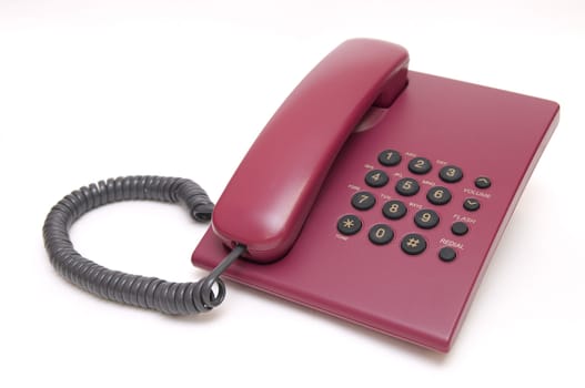 Traditional office red phone isolated on white background