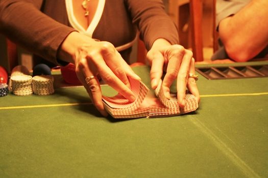 Woman playing poker shuffling cards
