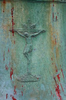 Old metalic Crucifix on green grunge background