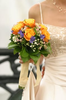 Wedding bouquet from yellow roses in hand of the bride