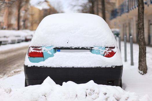 car in a street covered by a lot of snow