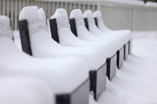 a few stone seats after a snowy night