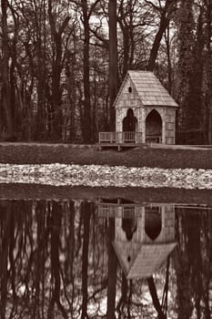 Gazebo near lake turned to sepia for vintage look