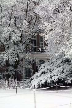 A houses surrounded by frosed trees