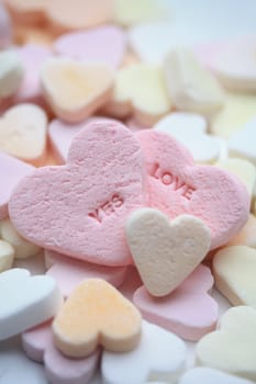 Valentine candy hearts in sweet colors, yes love