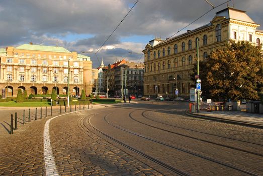 Prague street of bricks with tram lines going to brudge