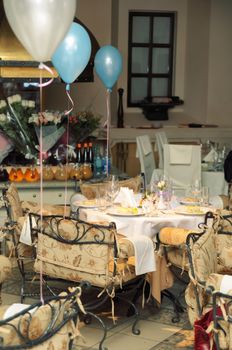 Wedding banquet table with white decoration in fine restaurant. Food served in plates