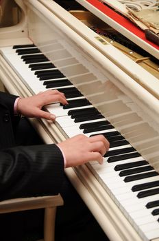 Man's hands playing piano
