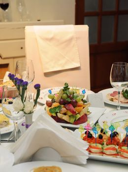 Wedding table and empty chair with decoration in fine restaurant with food served in plates