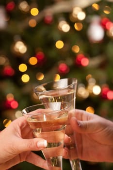 Man and Woman Toasting Champagne in Front of Decor and Lights.