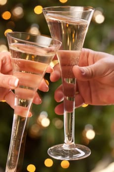 Man and Woman Toasting Champagne in Front of Decor and Lights.