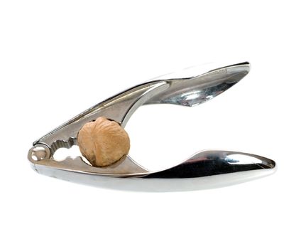 A silver nutcracker about to crack a walnut, isolated against a white background