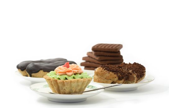 Various sponge cakes and cookies isolated on white background