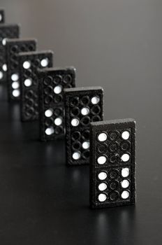 financial crisis concept with domino game on black background