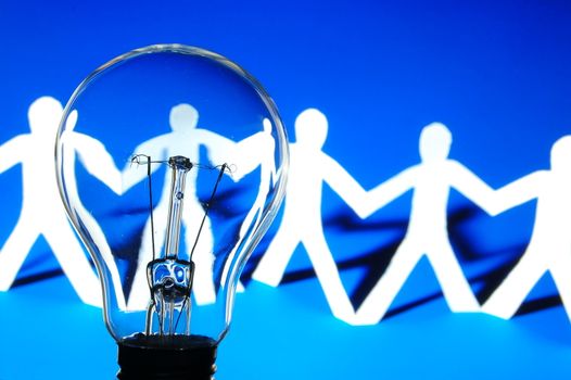 bulb and team of paper man showing concept of teamwork