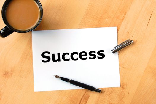 business success concept with pen paper and coffee in office