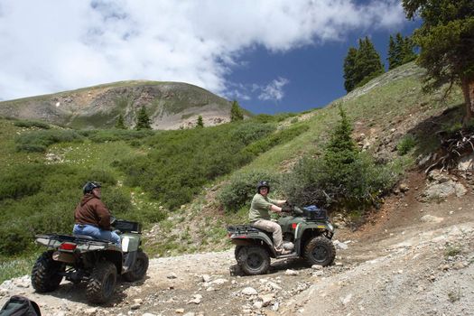 Two ATV riders pause on a trail on Mt. Princeton in the Colorado Rockies