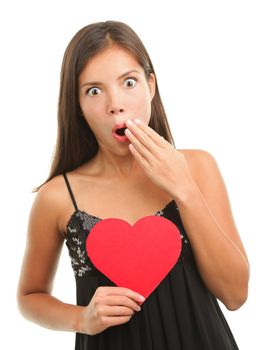 Woman in shock or embarrassed on valentine's day. Isolated on white background. Mixed race chinese / caucasian female model.