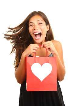 Valentines day woman very happy and excited for her gift / present. Beautiful mixed race asian / caucasian model isolated on white background. 