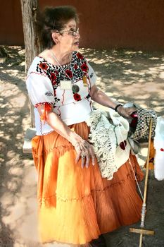 Storyteller spins yarn as she spins her tales of the past at centuries old hacienda in New Mexico