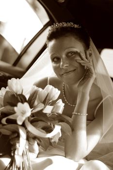 Beautiful the bride in car. b/w+sepia